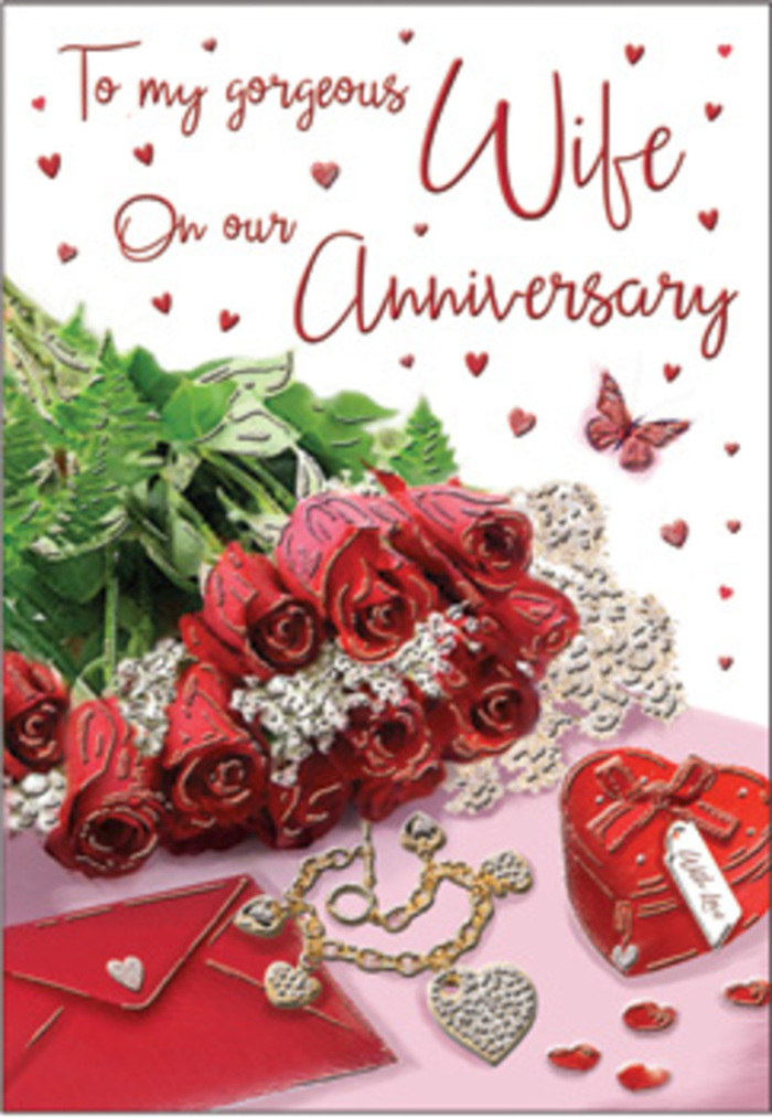 The scene captured on this anniversary card is thoughtfully composed, evoking the feeling of a cosy Charlton celebration where a couple trade flowers and gifts before heading out for an evening stroll. At the heart of the design is a rounded cluster of classic red roses, their petals full and luxuriant, spiralling inward in sumptuous layers of rich crimson. The blooms are arranged tightly together, almost overflowing, and are surrounded by deep green foliage whose glossy leaves curl and overlap, adding both contrast and a sense of natural abundance. Positioned nearby is a neatly set envelope, its lightly textured surface and soft, creamy tone suggesting fine stationery chosen for a special message. Just beyond, a heart-shaped box in striking red sits as a focal accent, its sides smooth and gently reflective, hinting at a meaningful gift hidden within. A delicate piece of jewellery, possibly a bracelet or necklace, winds gracefully beside it, the fine chain catching subtle highlights like sun glinting through trees around Maryon Park. Across the background of the card, small decorative hearts are scattered in gentle, irregular patterns, adding lightness and playfulness to the otherwise serene arrangement. A single butterfly motif floats above this field of hearts, symbolising gentle transformation and the unfolding of shared years. The card's message, written in elegant, sweeping script, flows across the design in curves that mirror the shapes of petals and ribbon. Soft, diffused light illuminates the entire setting, casting mild shadows that bring depth without harshness. The result is a richly romantic, tactile composition that feels grounded in everyday life-an ideal expression of enduring love for couples who call Charlton and its quiet, leafy streets home.